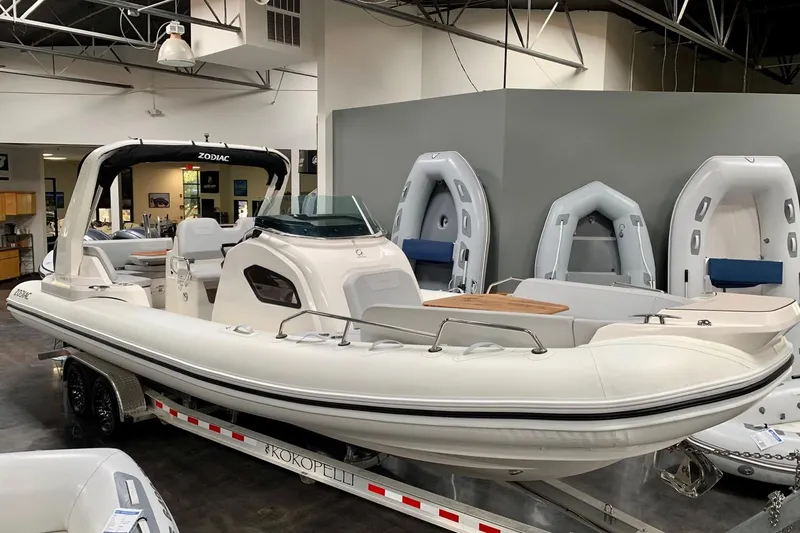 The Image of 2023 Zodiac Medline 9 inflatable boat displayed indoors on a trailer. - 0
