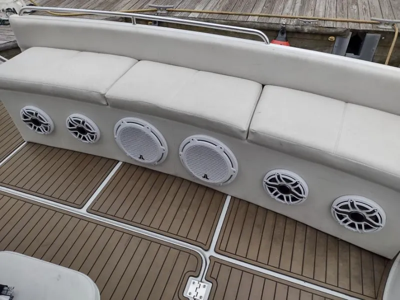 Slide: The Image of 1999 Carver 530 Voyager Pilothouse boat with cushioned seating and built-in speakers. - 19