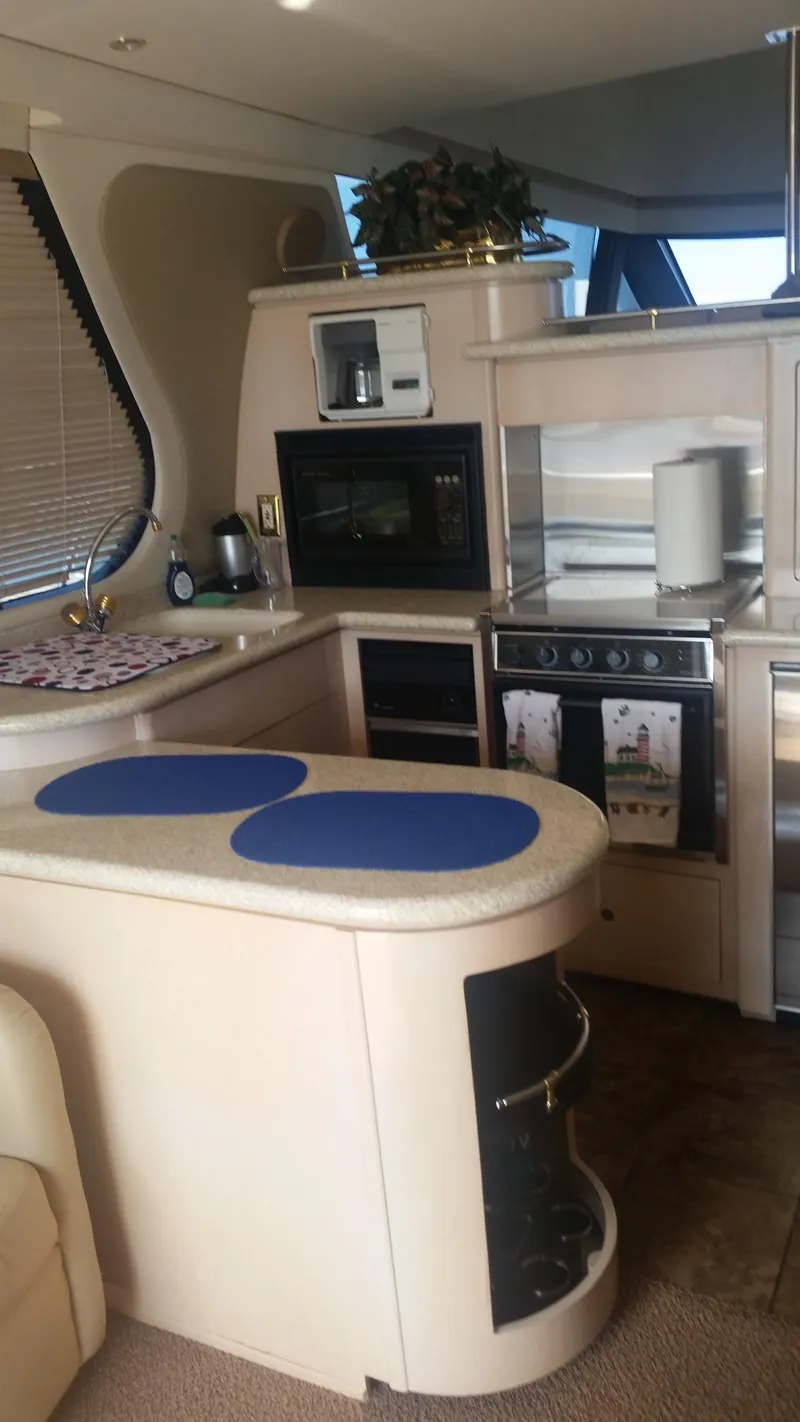 Slide: The Image of 1999 Carver 530 Voyager Pilothouse kitchen with modern appliances and sleek design. - 21