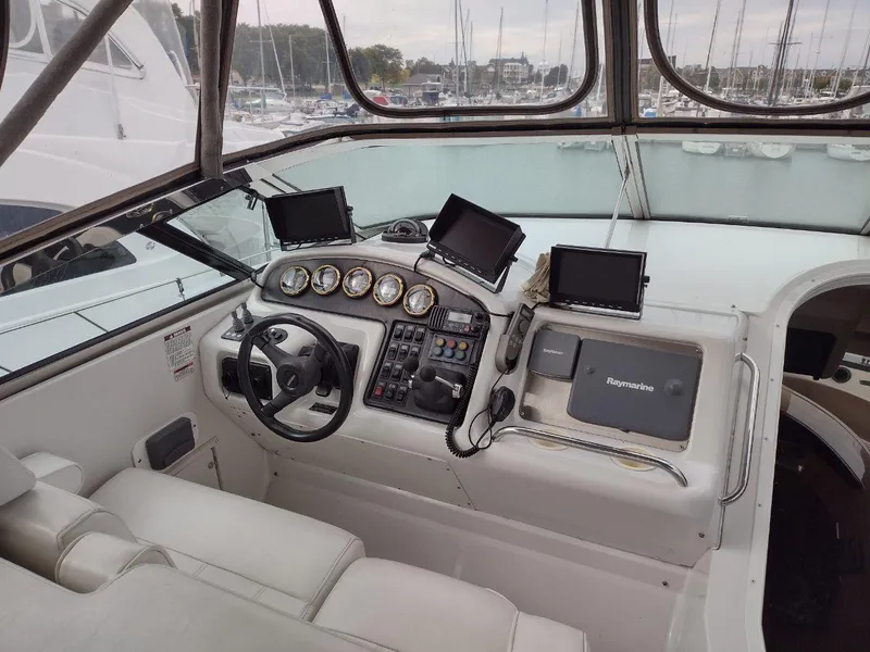 Slide: The Image of 1999 Carver 530 Voyager Pilothouse helm with multiple navigation screens and controls. - 5