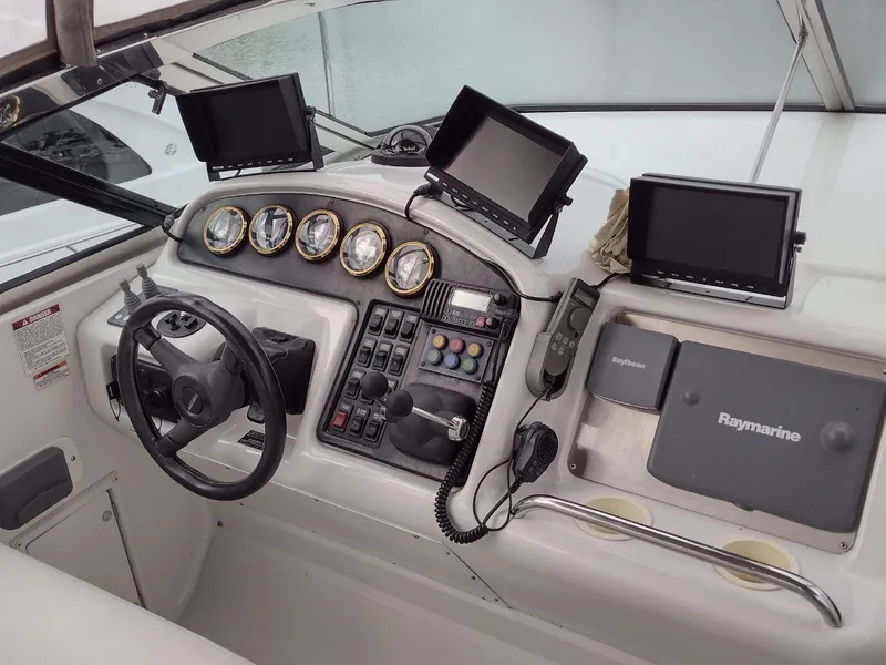 Slide: The Image of 1999 Carver 530 Voyager Pilothouse helm with navigation equipment and control panel. - 6