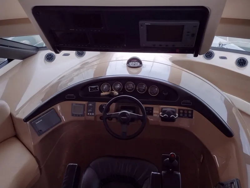 Slide: The Image of 1999 Carver 530 Voyager Pilothouse helm station with steering wheel and navigation instruments. - 8