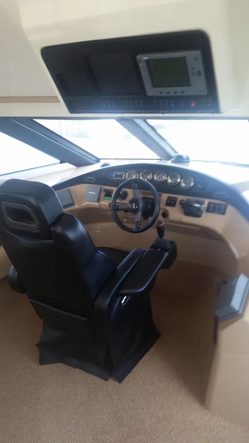 Slide: The Image of 1999 Carver 530 Voyager Pilothouse helm with modern navigation equipment. - 11