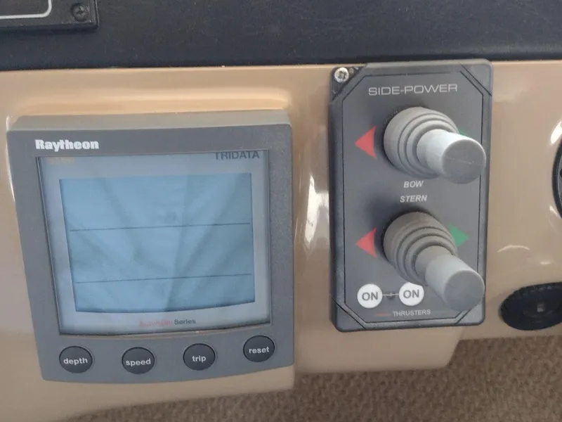 Slide: The Image of Raytheon Tridata display and Side-Power thruster controls on 1999 Carver 530 Voyager Pilothouse. - 12