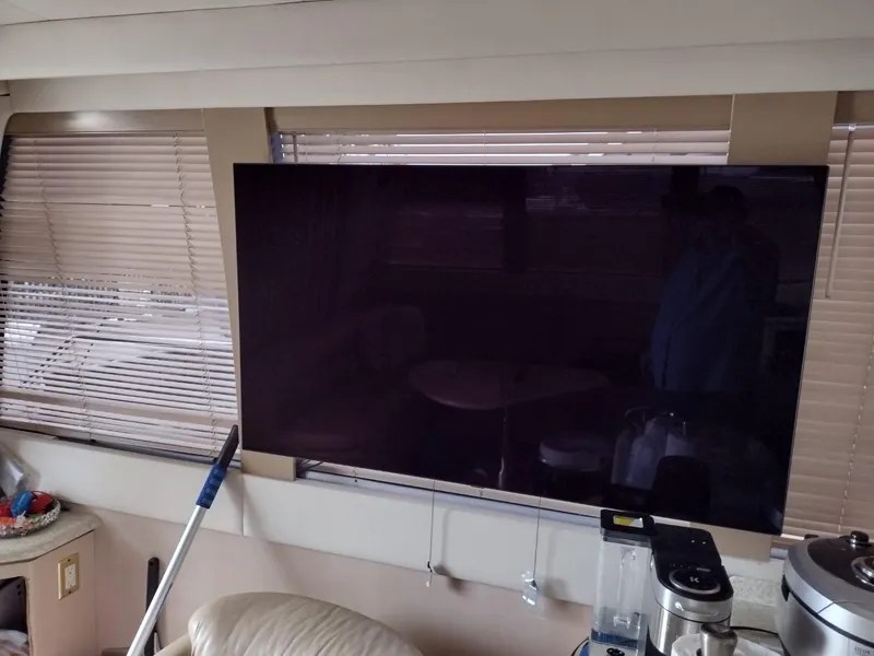 Slide: The Image of Interior of a 1999 Carver 530 Voyager Pilothouse with a mounted flat-screen TV. - 15