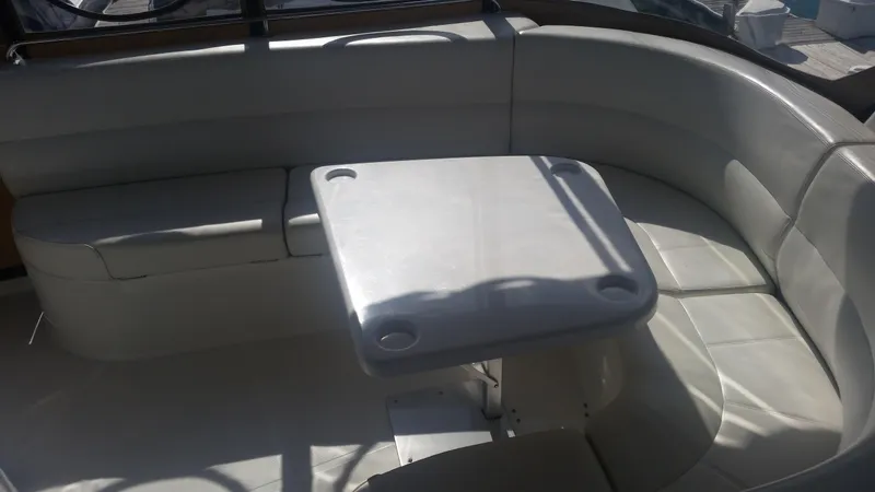 Slide: The Image of 1999 Carver 530 Voyager Pilothouse interior seating area with table. - 26