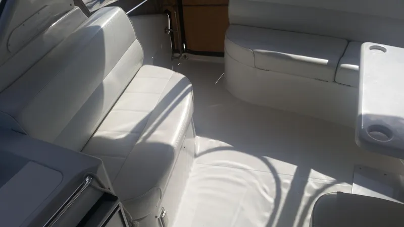 Slide: The Image of 1999 Carver 530 Voyager Pilothouse interior seating area with white upholstery. - 27