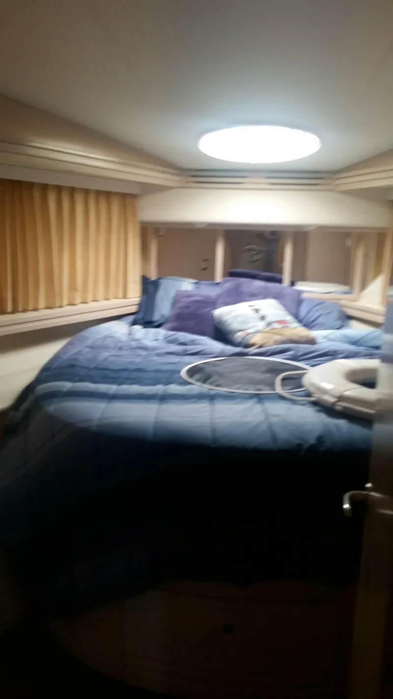 Slide: The Image of 1999 Carver 530 Voyager Pilothouse bedroom with circular bed and skylight - 36