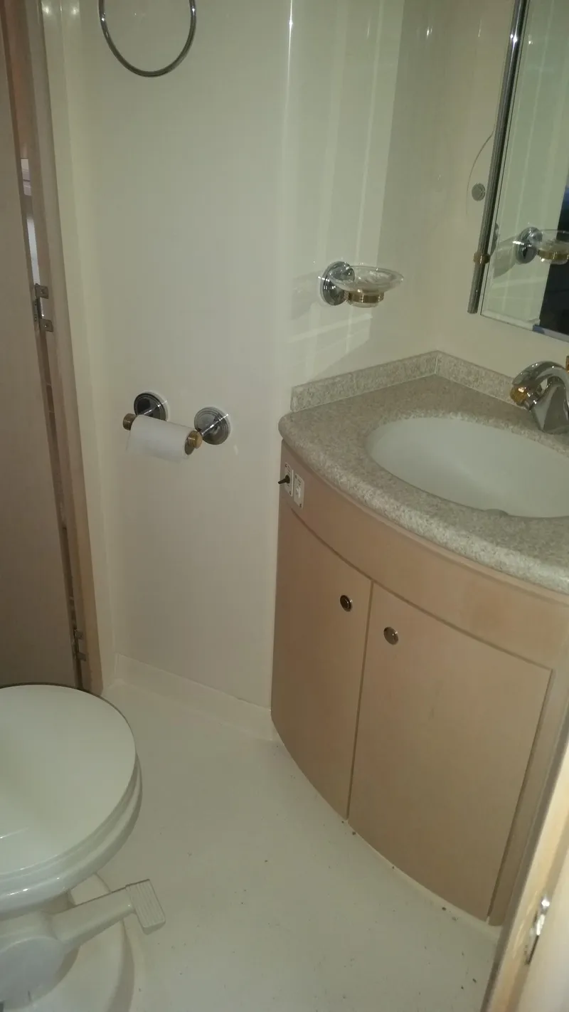 Slide: The Image of 1999 Carver 530 Voyager Pilothouse bathroom with sink, toilet, and mirror. - 39