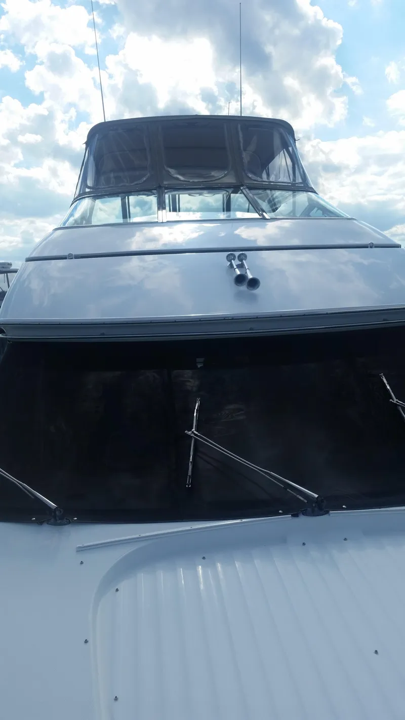 Slide: The Image of 1999 Carver 530 Voyager Pilothouse yacht under a cloudy sky. - 41