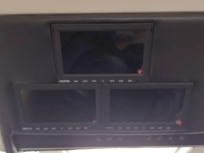 Slide: The Image of Three black screens on the dashboard of a 1999 Carver 530 Voyager Pilothouse. - 9