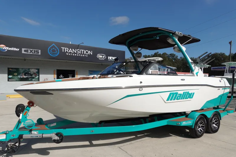 Slide: The Image of 2023 Malibu Wakesetter 23 LSV boat on trailer in front of store. - 1