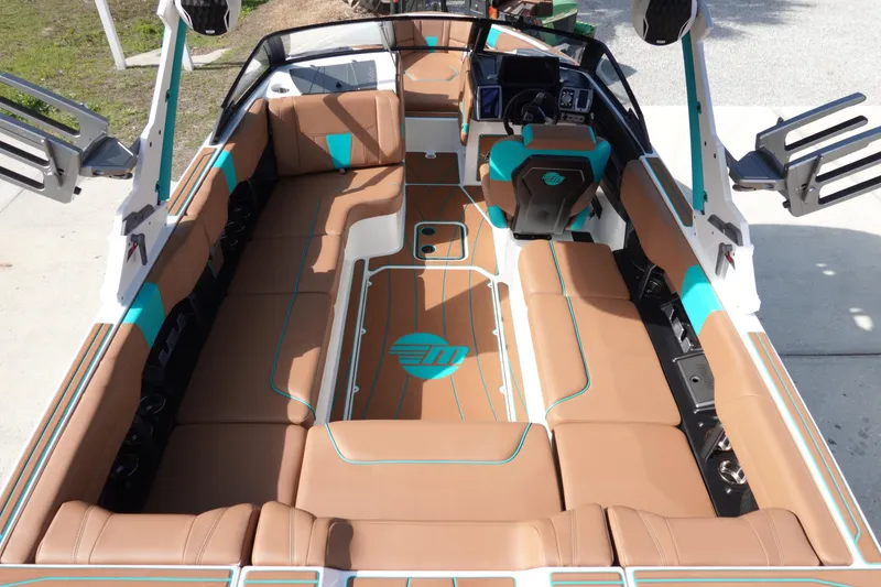 Slide: The Image of 2023 Malibu Wakesetter 23 LSV interior with tan and teal seating. - 10