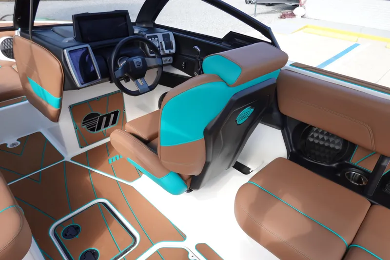 Slide: The Image of 2023 Malibu Wakesetter 23 LSV interior with brown and teal seating. - 15
