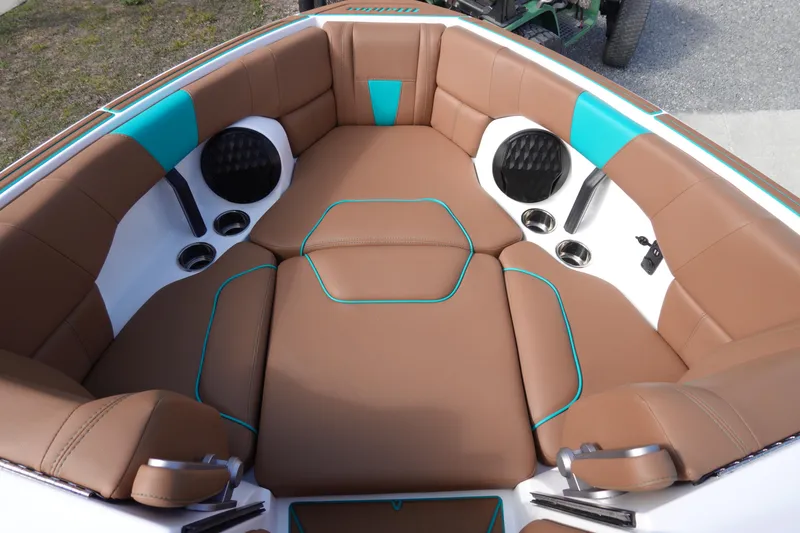 Slide: The Image of 2023 Malibu Wakesetter 23 LSV boat interior with brown and teal seating. - 18