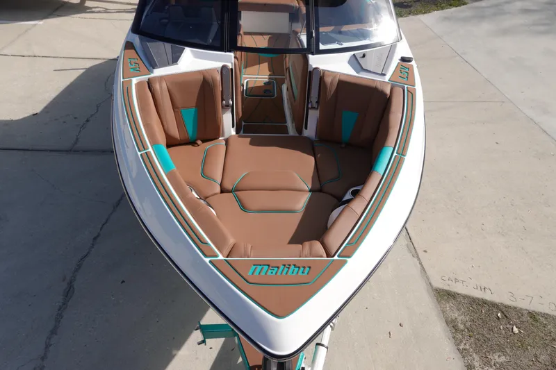 Slide: The Image of 2023 Malibu Wakesetter 23 LSV boat with brown and turquoise seating. - 2