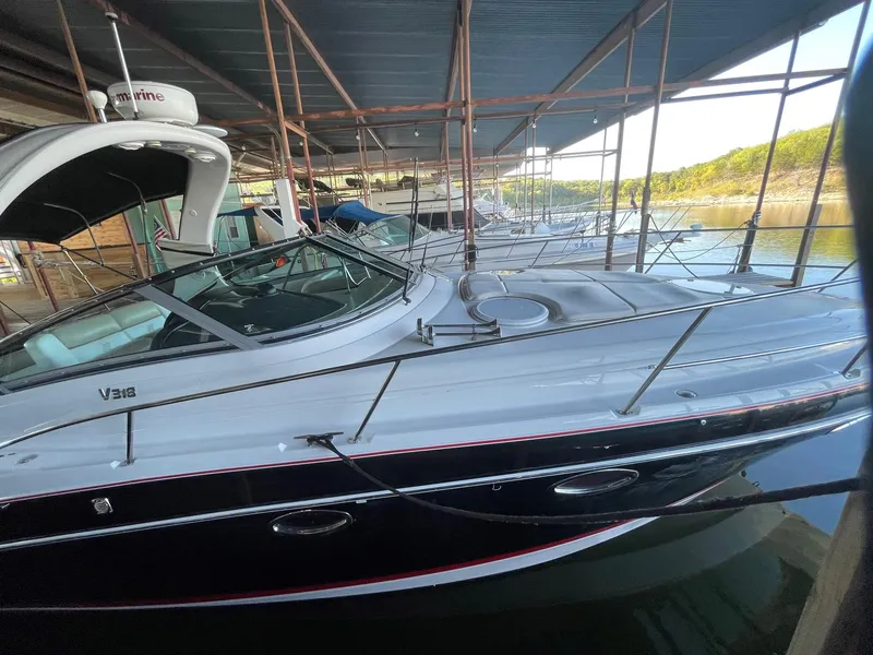 Slide: The Image of 2009 Four Winns V318 boat docked under a covered marina. - 10
