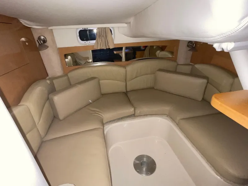 Slide: The Image of 2009 Four Winns V318 cabin interior with beige leather seating and wooden accents. - 19