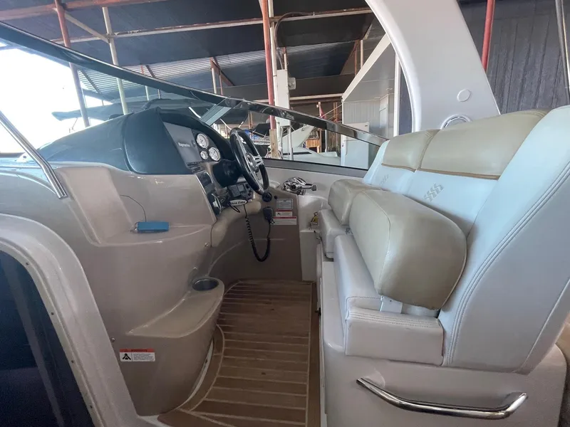 Slide: The Image of 2009 Four Winns V318 boat cockpit with beige seating and control panel. - 26