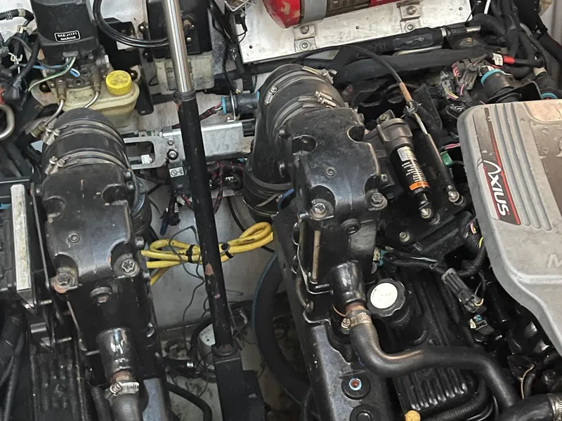 Slide: The Image of Engine compartment of a 2009 Four Winns V318 boat showing dual engines and components. - 29