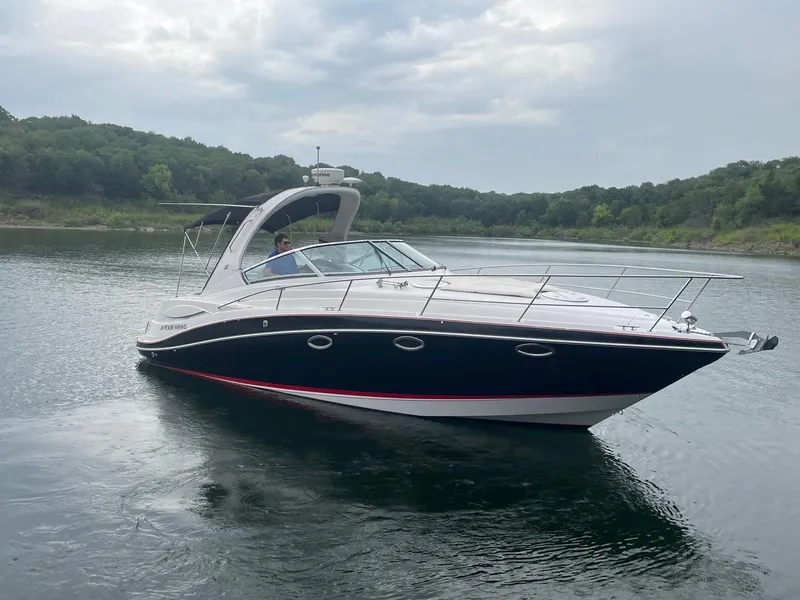 Slide: The Image of 2009 Four Winns V318 boat cruising on a calm lake. - 3