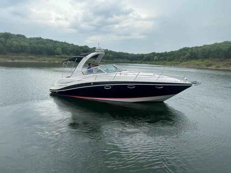 Slide: The Image of 2009 Four Winns V318 boat cruising on a calm lake. - 4