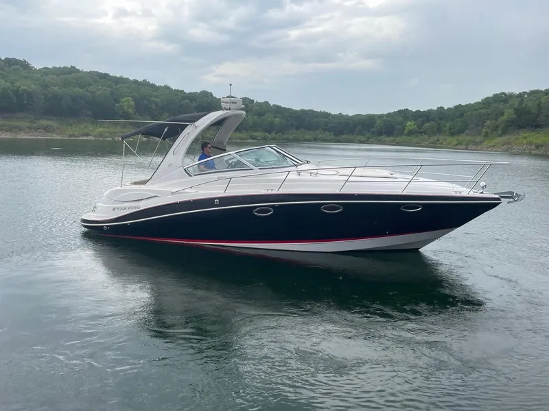 Slide: The Image of 2009 Four Winns V318 boat cruising on a calm lake. - 5