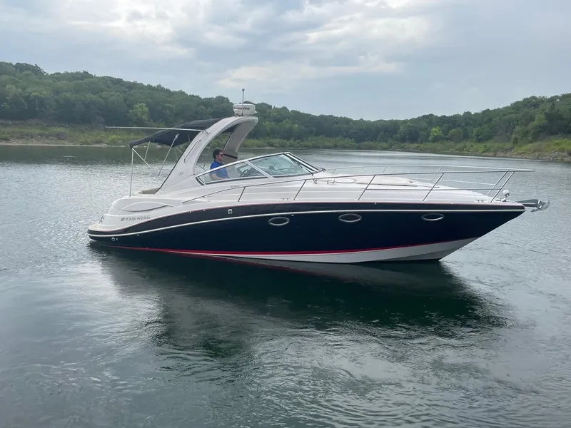 Slide: The Image of 2009 Four Winns V318 boat cruising on a calm lake. - 6