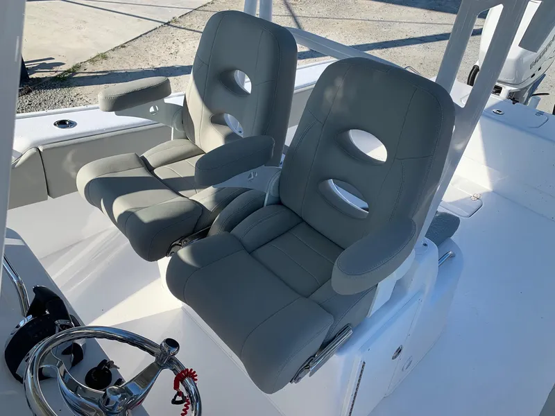 Slide: The Image of 2024 Cape Horn 31T boat with dual cushioned captain's chairs and steering wheel. - 11