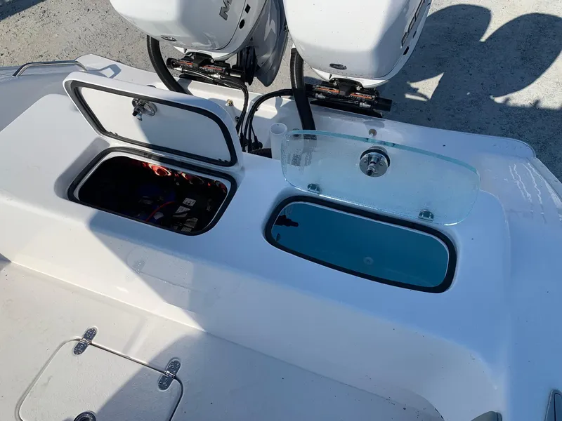 Slide: The Image of 2024 Cape Horn 31T boat with open storage compartments and twin outboard engines. - 5