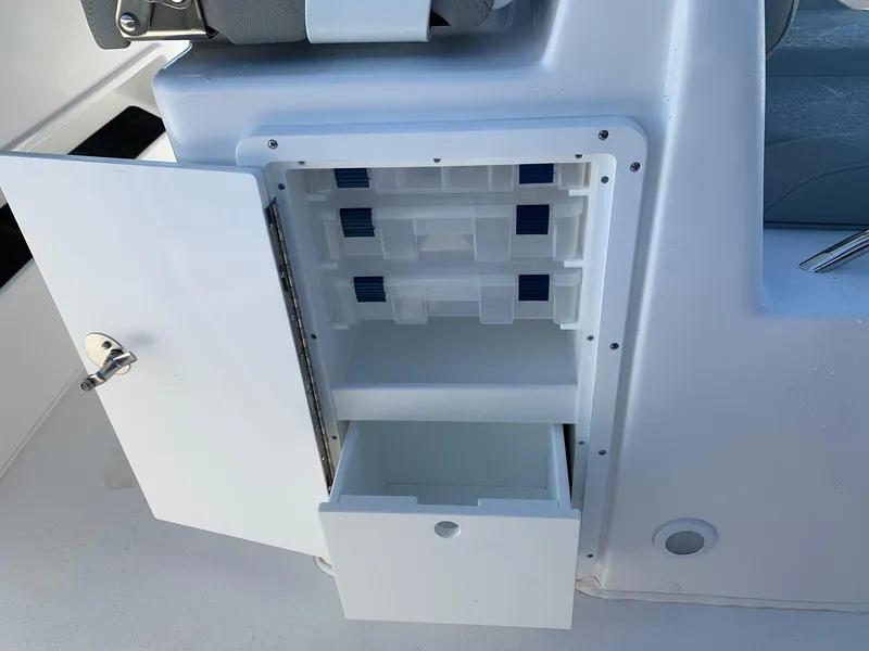 Slide: The Image of 2024 Cape Horn 31T boat storage compartment with open door and drawer. - 10