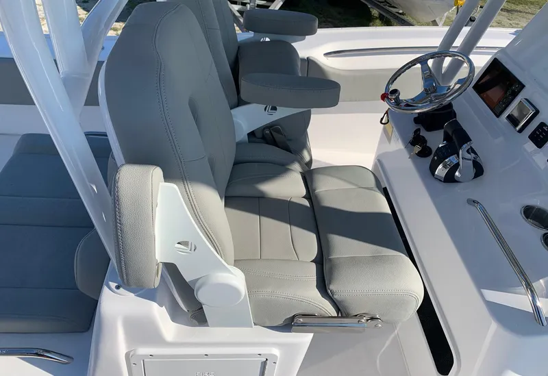 Slide: The Image of 2024 Cape Horn 31T boat interior with dual captain's chairs and steering console. - 12