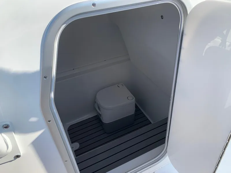 Slide: The Image of 2024 Cape Horn 31T boat interior storage compartment with portable toilet. - 14