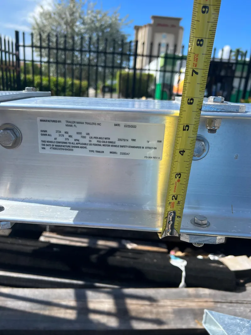 Slide: The Image of 2023 Trailer model measurement with tape measure, close-up view. - 2