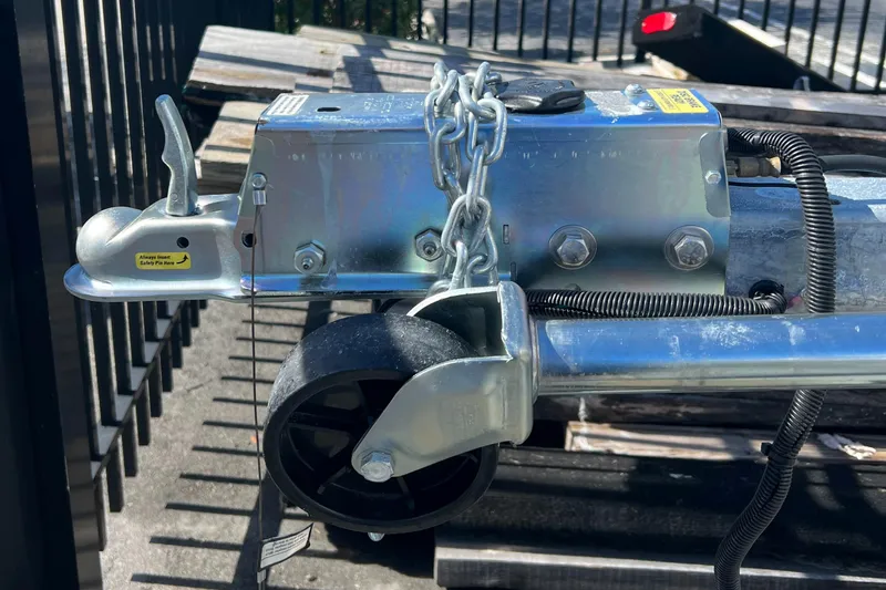 Slide: The Image of Close-up of a 2023 Trailer model TRAILERS hitch and wheel assembly. - 25