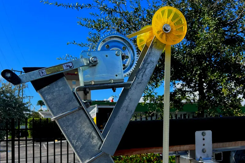 Slide: The Image of 2023 Trailer model with winch mechanism and yellow pulley in outdoor setting. - 28