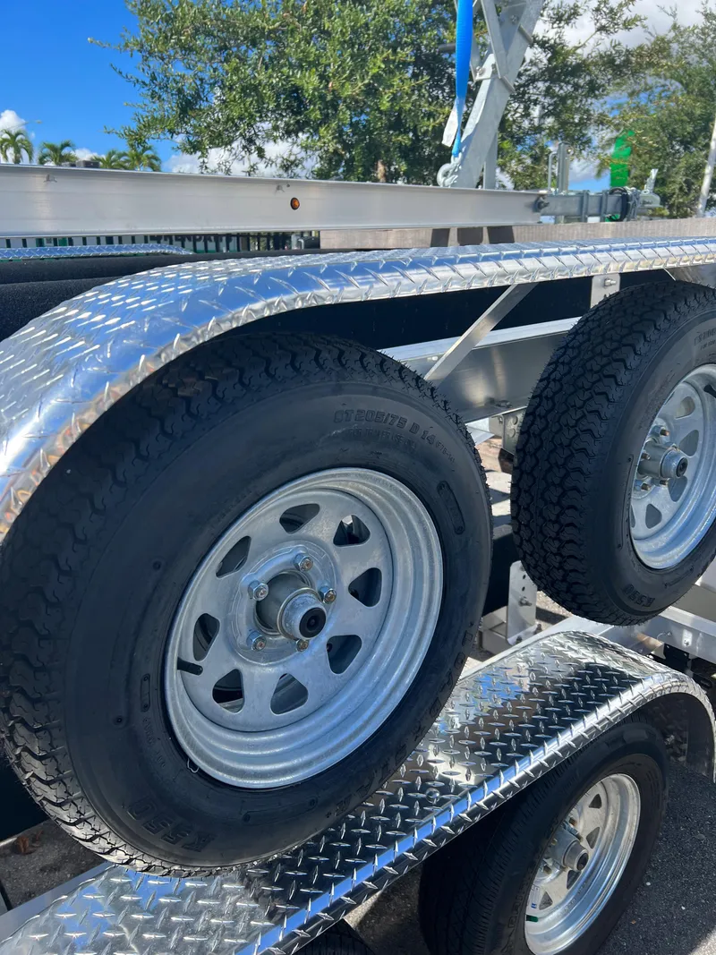 Slide: The Image of 2023 Trailer TRAILERS model with dual wheels and diamond plate fenders. - 4