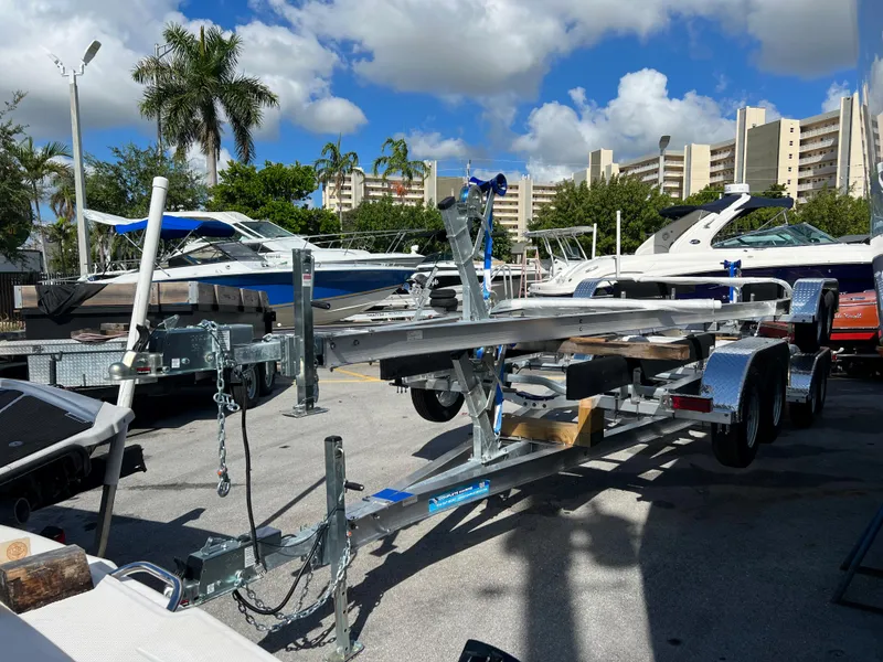 Slide: The Image of 2023 Trailer TRAILERS model in a marina with boats and palm trees. - 8