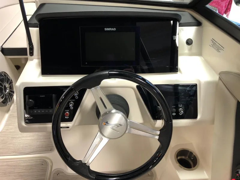 Slide: The Image of Steering console of 2023 Sea Ray 190 SPO boat with Simrad display. - 10