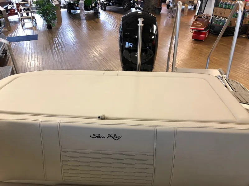 Slide: The Image of 2023 Sea Ray 190 SPO boat interior with outboard motor in showroom. - 13