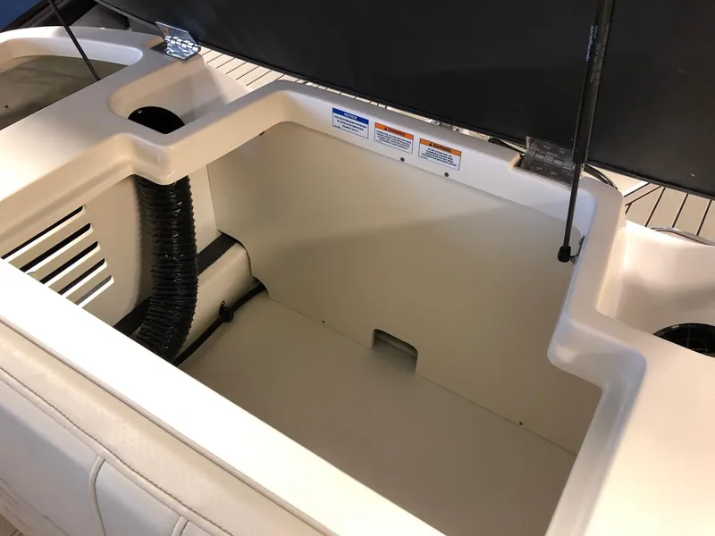 Slide: The Image of 2023 Sea Ray 190 SPO boat storage compartment with open hatch. - 14