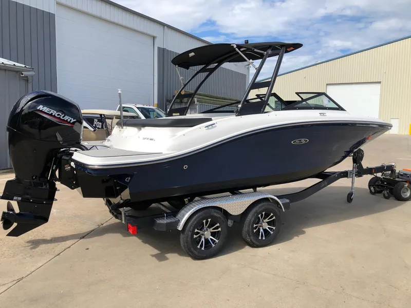 Slide: The Image of 2023 Sea Ray 190 SPO boat on a trailer with a Mercury outboard motor. - 2