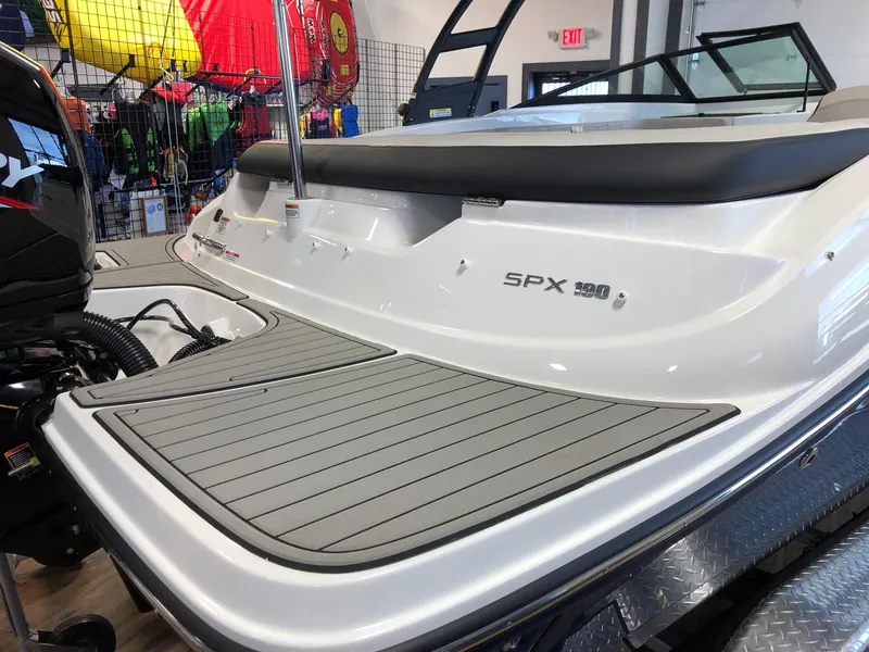 Slide: The Image of 2023 Sea Ray 190 SPO boat rear view with SPX 190 branding in showroom. - 4