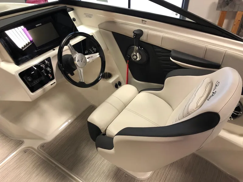Slide: The Image of 2023 Sea Ray 190 SPO boat interior with steering wheel and captain's chair. - 9