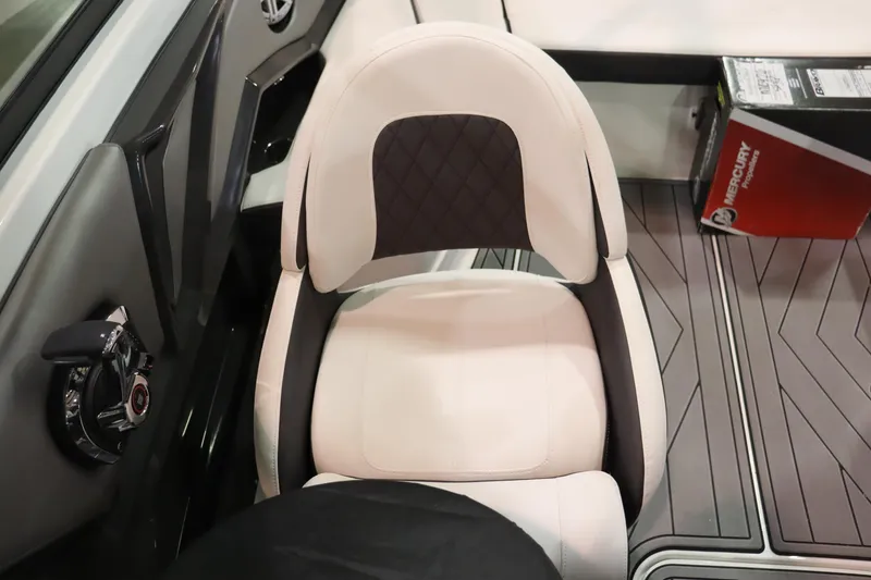 Slide: The Image of Captain's seat of a 2023 Monterey 238 Super Sport boat with a Mercury box nearby. - 11