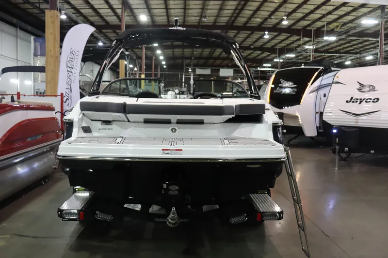 Slide: The Image of 2023 Monterey 238 Super Sport boat displayed in an indoor showroom. - 3