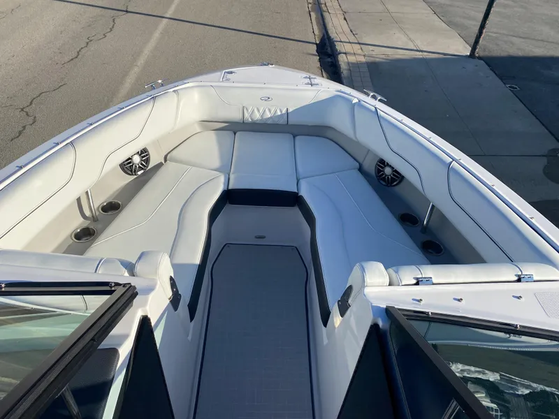 Slide: The Image of 2023 Regal LS6 Surf boat interior with white seating and built-in speakers. - 4