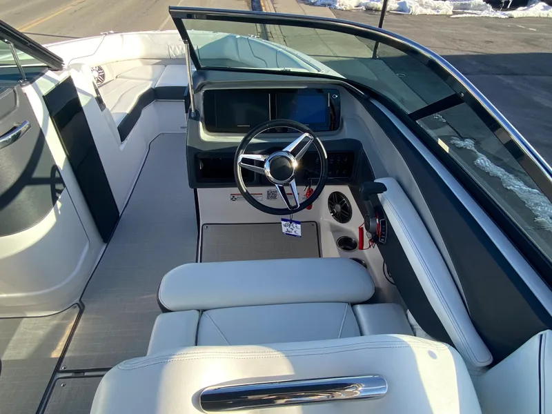 Slide: The Image of 2023 Regal LS6 Surf boat interior with steering wheel and dashboard. - 5