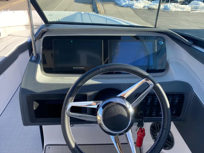 Slide: The Image of 2023 Regal LS6 Surf boat dashboard with steering wheel and digital displays. - 6