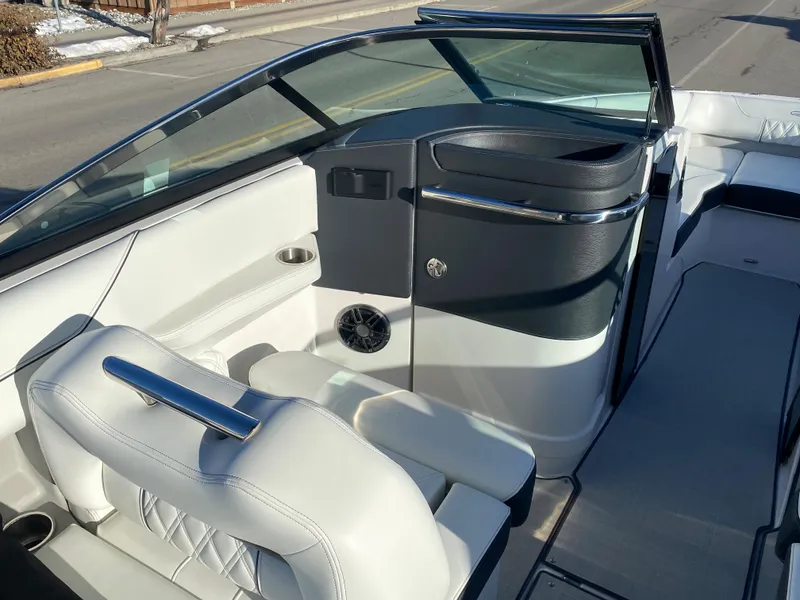 Slide: The Image of 2023 Regal LS6 Surf boat interior with white leather seats and modern dashboard. - 7